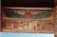 This typical ancient Egyptian winged sun disk symbol hovers on the lintel of a temple entrance. The green color of the wings is noteworthy in that modern observers of total solar eclipses have reported a greenish tinge to the sun's corona 